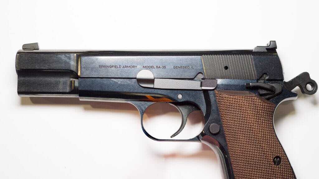 View of the left side of the gun, cropping the bottom of the grip with the hammer cocked.