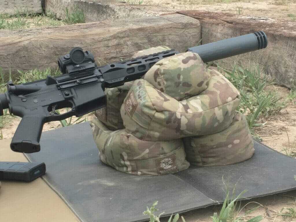 SBR with suppressor on table showing NFA features barrel under 16 inches and silencer