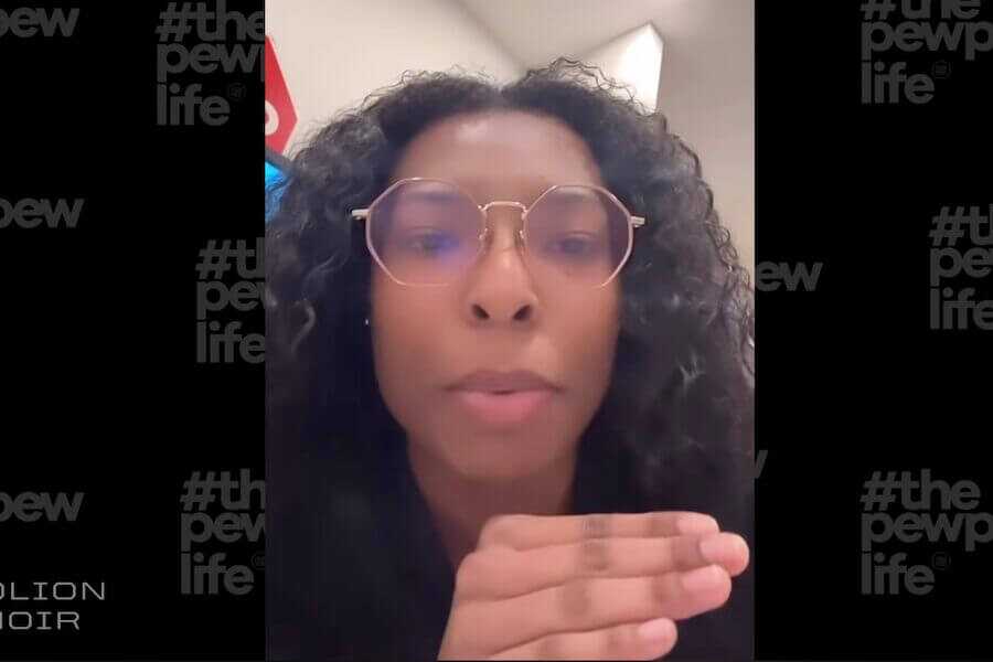 A woman pictured, discussing how difficult it is to buy a gun in a gun store.