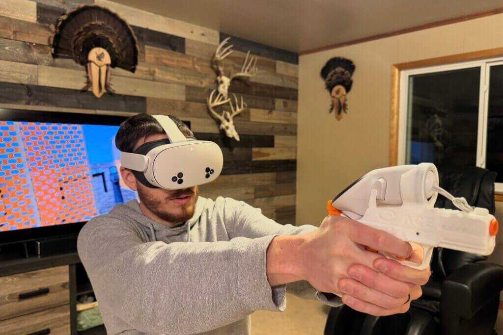 ACE VR shooting simulator with Meta Quest and dedicated pistol handset on table, ready for at-home USPSA practice