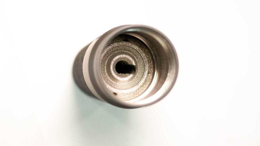 The entry end of the supproessor standing on a table.