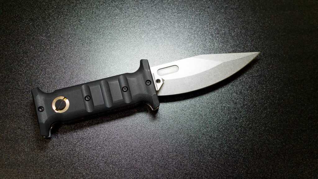 The short version of the knife laying on a table.