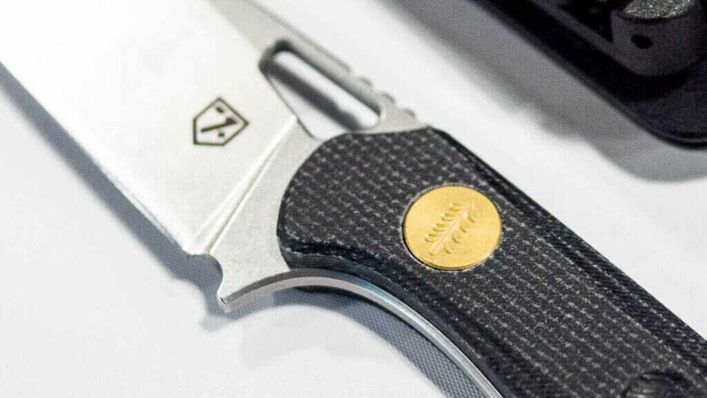 Close up view of the top of the scales showing the scrollwork on the fastener.