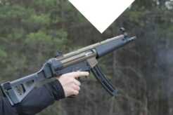 An arm holding a braced pistol.