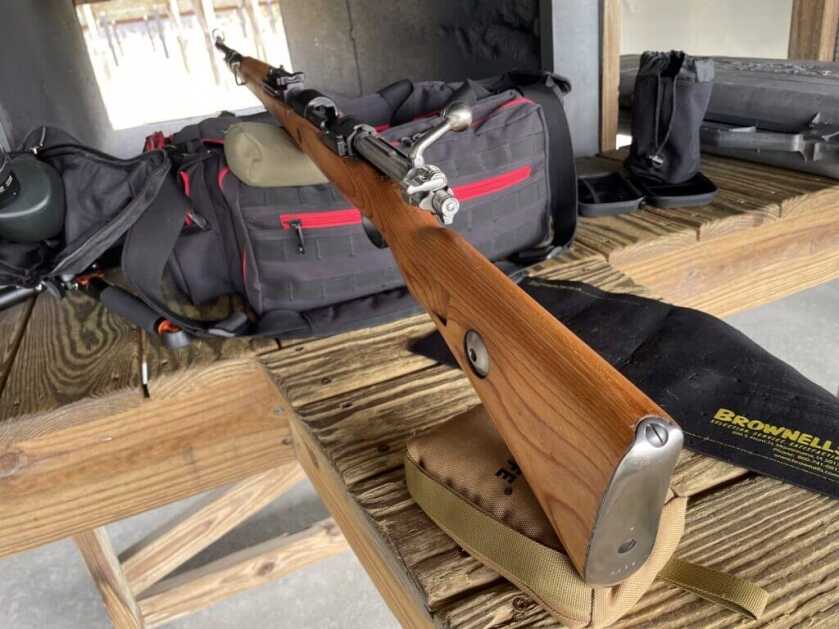 Mauser 98k rifle resting on range bench during shooting test