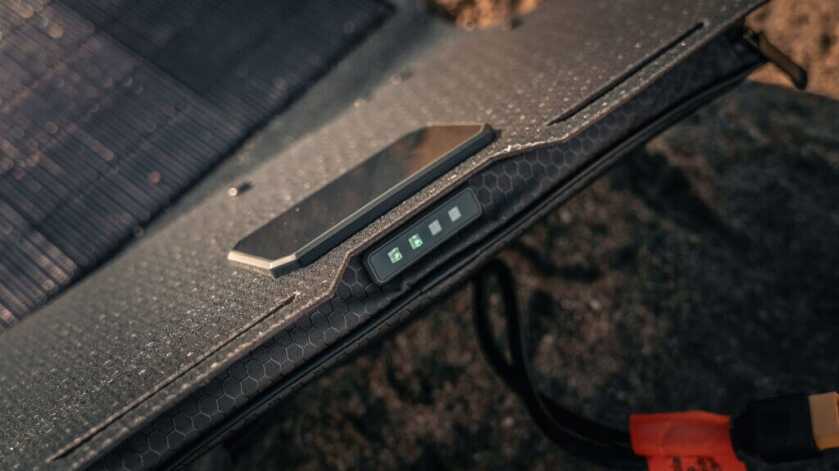 Dark Energy Spectre 56W solar panel LED sun meter showing charging efficiency in the field