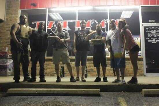 Store owners in Ferguson line up to defend their shop in the latest round of riots.