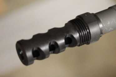 The muzzle brake is threaded to accept the steel sleeve.