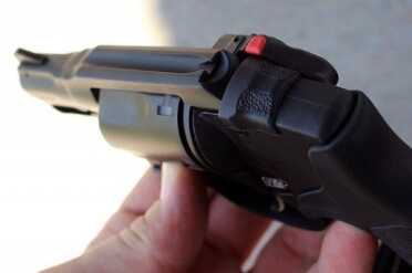 The top sight rail is a deep trench. Not adjustable, but is won't snag, either.