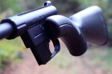 The left side of the gun protrudes out. This is where the barrel sits when compacted.