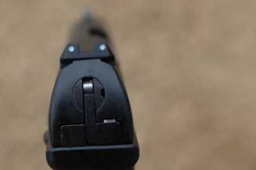 This is a picture of the slide catch. Ignore the sights and look at the shiny steel nubbin. That's what's holding the catch that keeps the slide in place. 