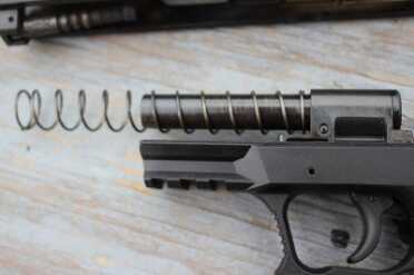 The spring rides on the fixed barrel.