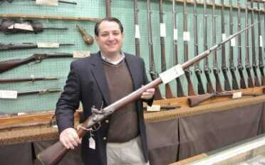 Selling History-Cohen and Sons of New Orleans Barry Cohen holds an 1800 dated Brown Bess.