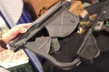 Empty and open.  The tube on top of the stock can hold batteries. 