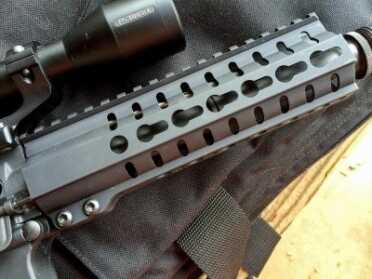 KeyMod attachment points are at the 3, 6, and 9 o'clock positions. The Picatinny rail covers the receiver and hand guard.