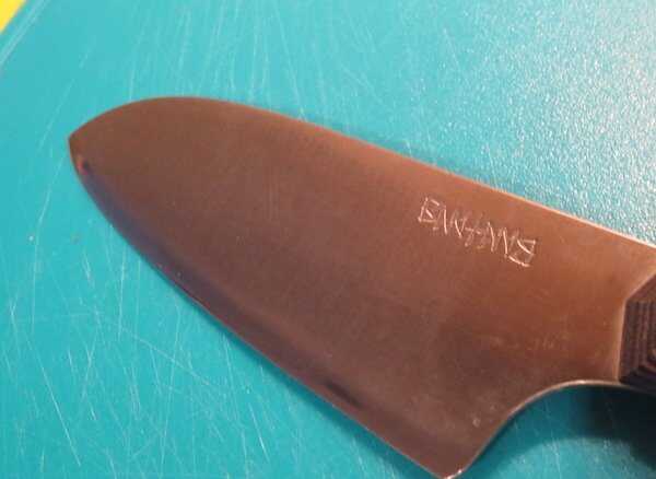 A close up of the blade on the Santoku.  
