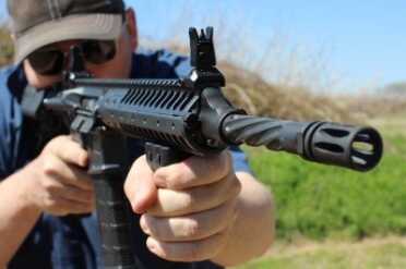 The piston system rides under the rail, and it works. Some see it as one-more-thing to break on an AR, but I've yet to find fault with it.