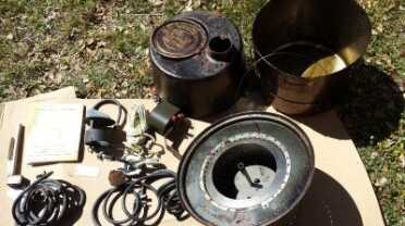 These are the parts that came with my stove. Top right are the top and bottom cans, then below is the burner assembly and to the left the fuel regulator, fuel lines, can adapter and vent pipes. As you can see, they are somewhat corroded and rusted because the box had gotten wet and stayed wet for months. 