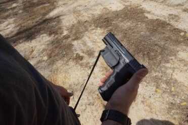 Tie it down, or you will have a hard time making the gun go bang.