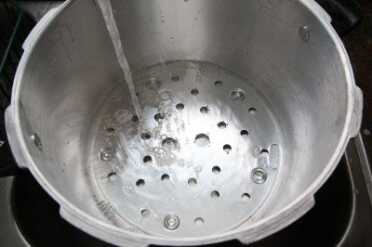 You only need a few inches of water in your canner. Very little steam escapes even over an hour or more with the weight on.