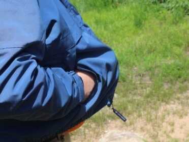 Shooting Revolvers and Autos From the Pocket The nylon coat offered nice concealment, and the gun poked through the hole easily for better follow-up shots.