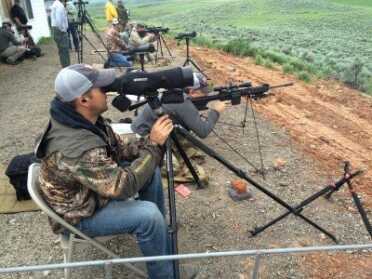 1,000 Yards with a Stock .308 AR-15 Style M&P Model 10? Note the Double Crossed shooting sticks being used by my shooter/spotter partner. He's got an incredibly stable hold from a field sitting position. That's our instructor Dusty on the spotting scope.