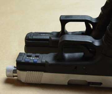 The rounded over trigger guard next to the concave guard on the GLOCK.