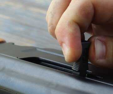 Pull the lever away from the gun and the bolt locks open.