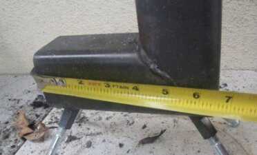 The measurements from the corner on this stove are 6 1/2" wide x 9" tall.  The baffle piece is 5" and has wings that are bent to hold it in. 