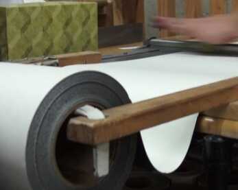 Material from the raw rolls is cut into machine-sized panels for the laser cutters.