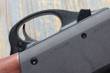 The action bar lock is forward of the trigger guard.