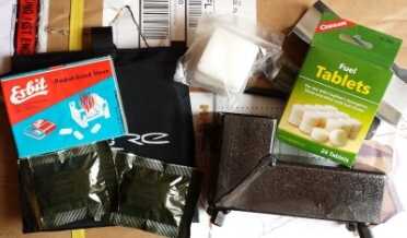 I would also include an alcohol stove if you can. Walmart has  Esbit type stoves for cheap, and this black stove is on Ebay for like $30. It is a backpackers rocket stove  and comes with solid fuel and can also burn sticks. 