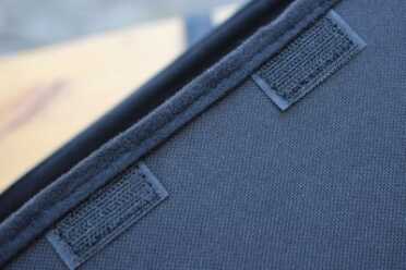 The flap is held in place by hook-and-loop closures.  