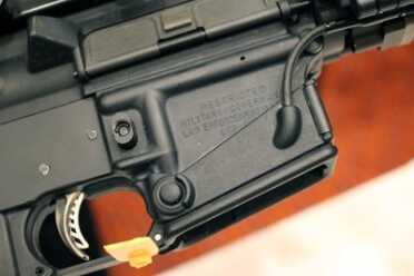 The light activation on the AR version has a push button and a trigger activation.