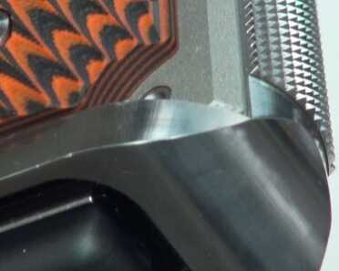 The Nighthawk magwell and mainspring housing is a one piece and also has 25 lpi checkering.