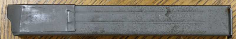 Magazine double row storage with single row feed.