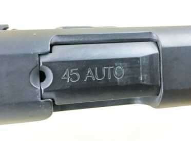 The small hole is a chamber status indicator. You can see, but not feel, if there is a cartridge in there.