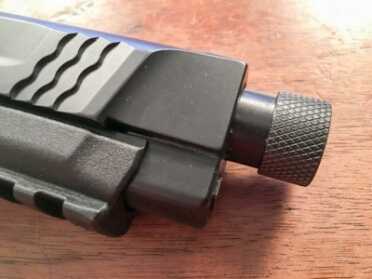 The threaded barrel is exactly 1/2-inch longer than the standard and comes with a thread protector. 