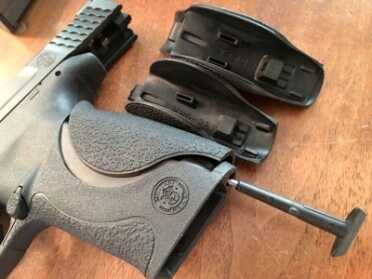 You change the backstrap panels by removing this pin from the base of the magazine well. This tool doubles as a sear release for takedown. 