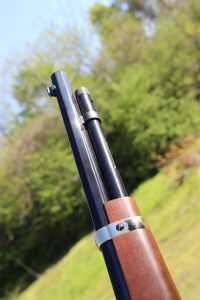 The cap on the loading tube turns and pulls up to allow loading. 