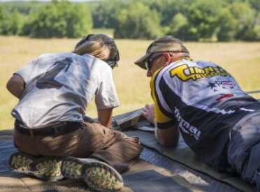Kids And Guns: Teach Your Children Well Instructor Tommy Thacker helping junior Dakota Overland understanding long range rifle holds during the 2A Heritage Junior camp. Photo Credit: Todd Overland.
