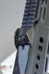 The rear sight unit, mounted on the Picatinny rail, features heavy duty protective wings.