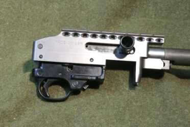 Customized Rimfire For Fighting Dangerous Domestic Terrorists! The receiver of the MagnumLite rifle features an integral strip of rail for attaching optics.