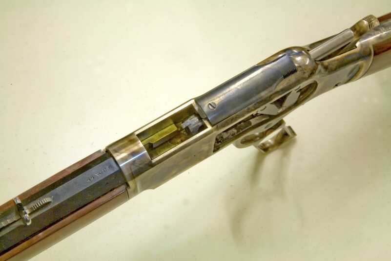 Cowboy Time Machine: Uberti 1873 Carbine—Better Than The Original? Full Review. The heart of the 1873 design is its toggle-link action located inside the receiver. Note the top-ejection port and sliding dustcover.