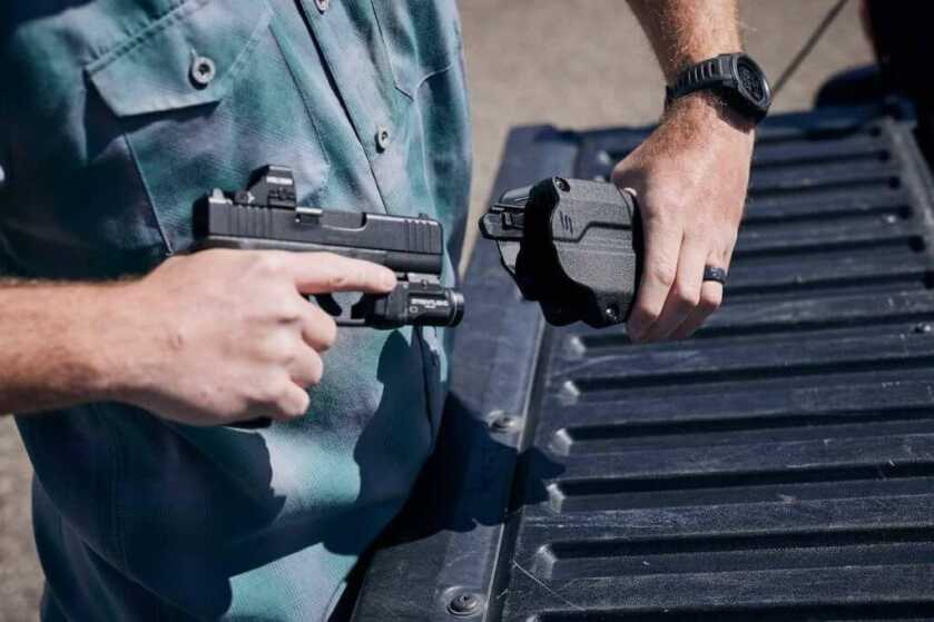 Man with a gun and a Solis holster.