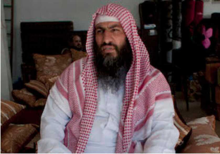 abu sayyaf sitting in a room