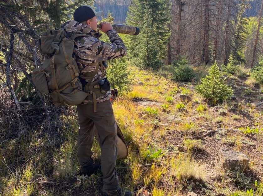 5 Pieces of Backcountry Elk Gear You Don't Want To Forget Hunter in the backcountry blowing through his elk bugle