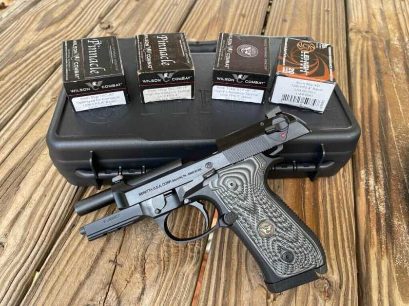 Wilson Combat Beretta 92G with the Wilson Combat premium ammunition on top of wood slabs