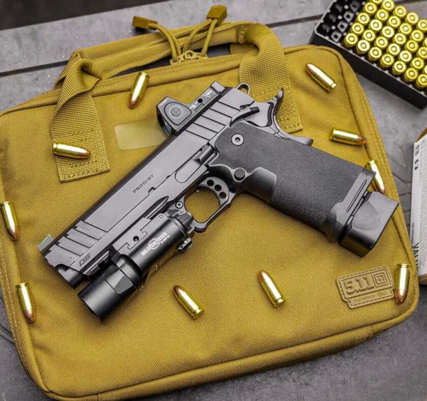 Springfield Prodigy handgun lays on tan 5.11 pistol case.