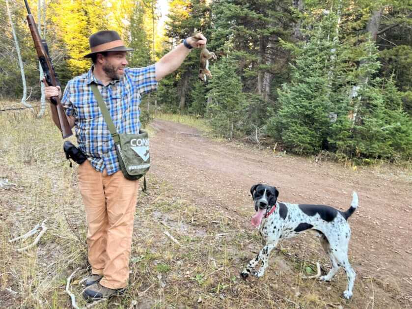 Shooter with gun and dog